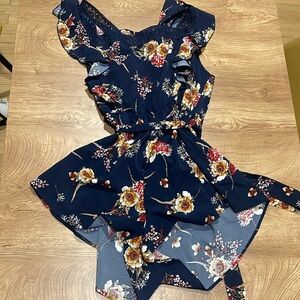 Navy blue floral romper with lace accents and tie back